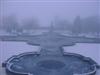 A view of the frozen water behind the war memorial with the Queen Victoria monument in the distance